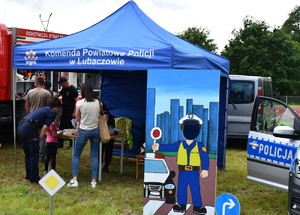 Na zdjęciu namiot z napisem Komenda Powiatowa Policji w Lubaczowie, uczestnicy pikniku oraz fotobudka.